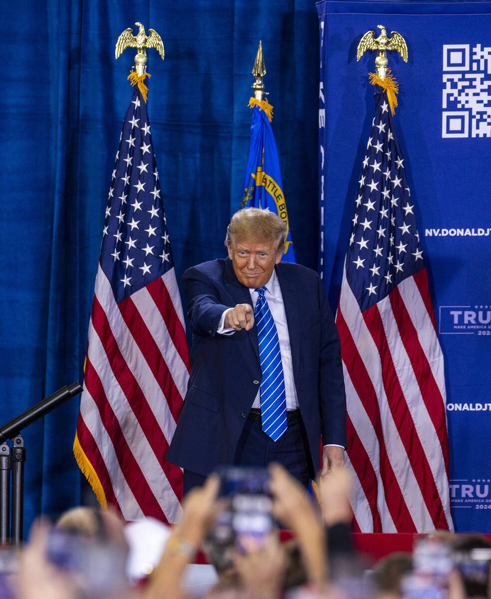 Republican presidential candidate former President Donald Trump points to the crowd while arriv ...