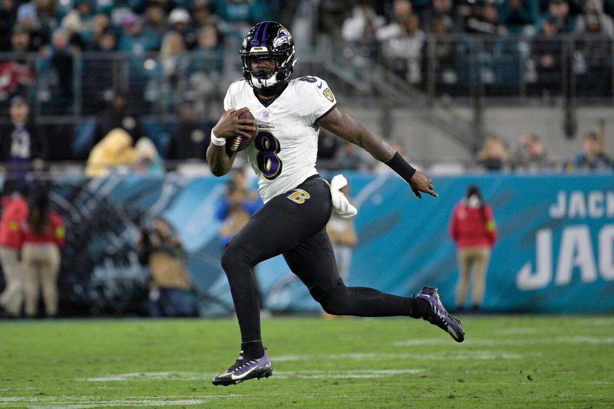 FILE - Baltimore Ravens quarterback Lamar Jackson (8) scrambles for yardage against the Jackson ...