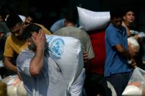 Palestinians storm a U.N.-run aid supply center that distributes food to displaced families fol ...