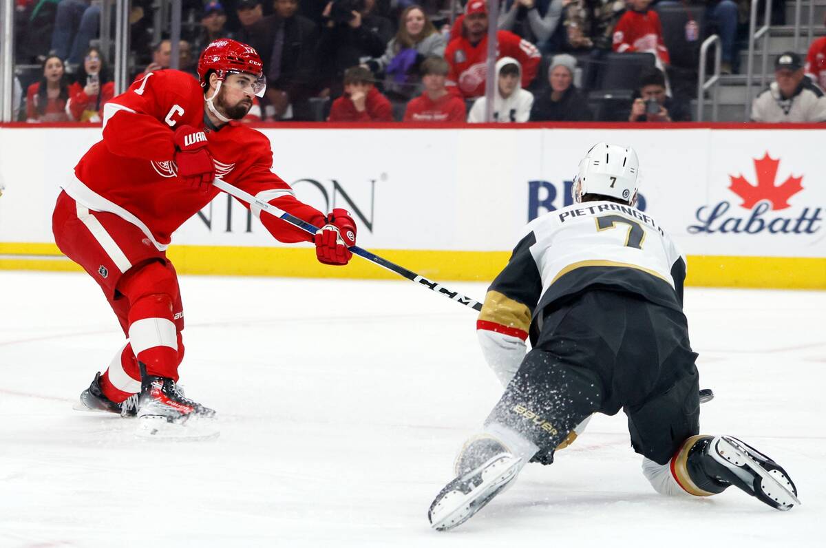 Detroit Red Wings center Dylan Larkin (71) shoots the puck past Vegas Vegas Golden Knights defe ...