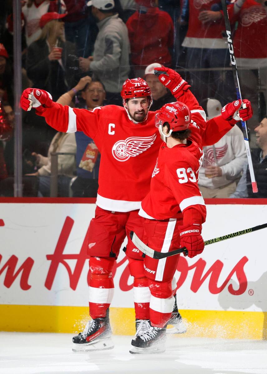 Detroit Red Wings center Dylan Larkin (71) celebrates with right wing Alex DeBrincat (93) after ...