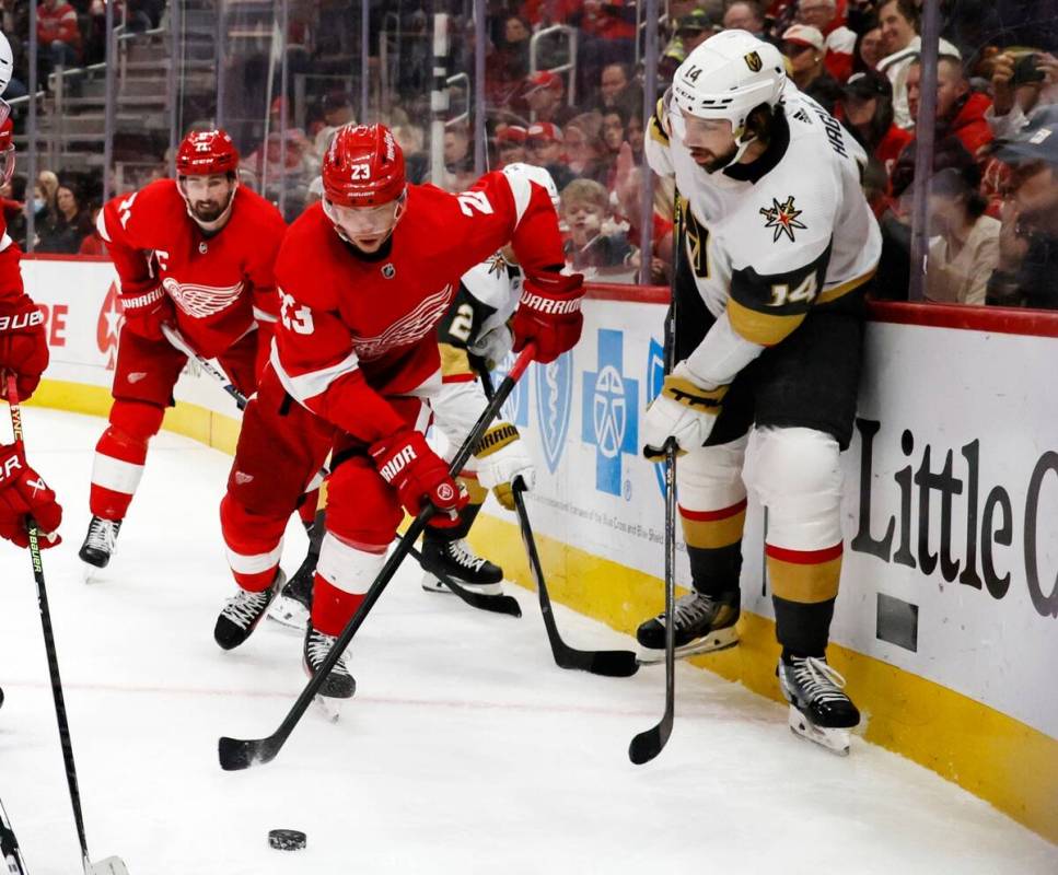 Detroit Red Wings left wing Lucas Raymond (23) takes the puck past Vegas Golden Knights defense ...