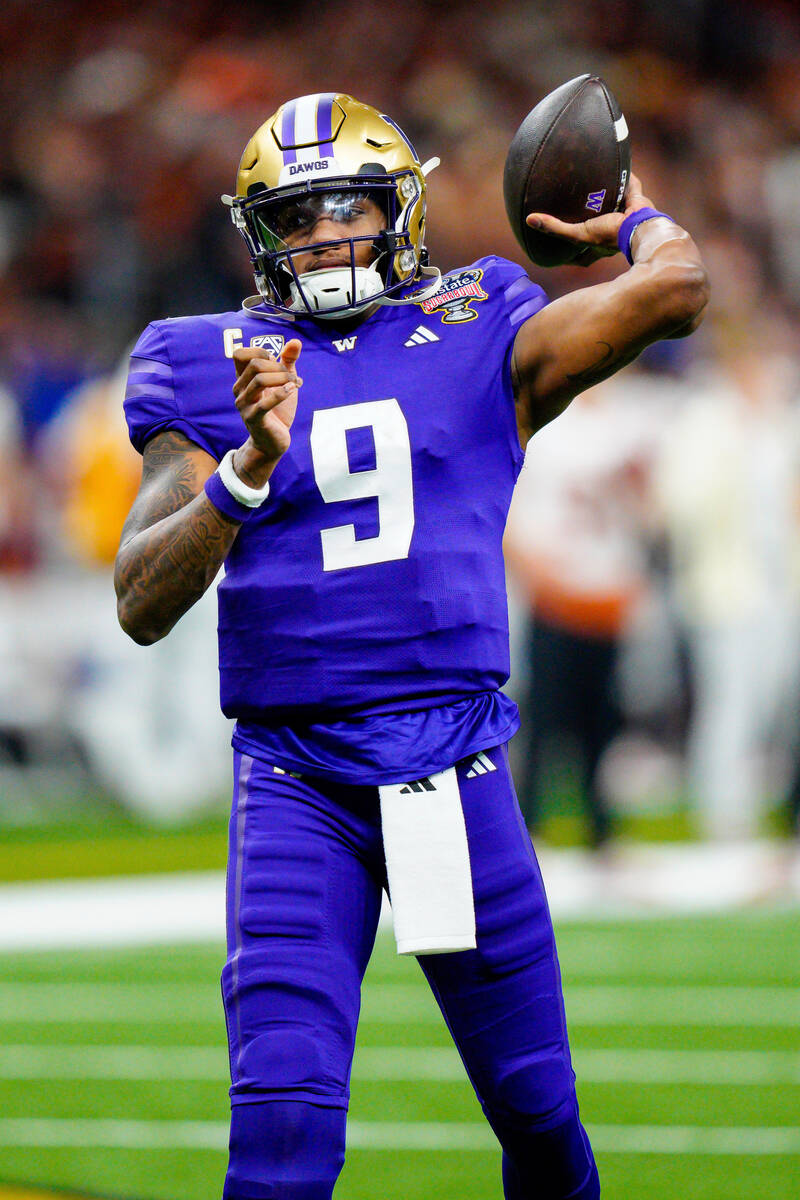 Washington quarterback Michael Penix Jr. (9) warms up before the Sugar Bowl CFP NCAA semifinal ...