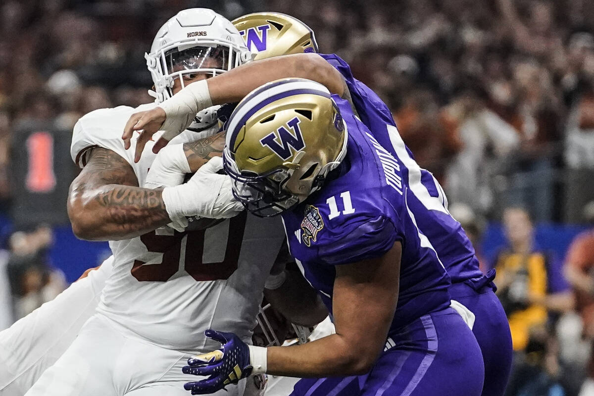 Texas defensive lineman Byron Murphy II (90) runs into the end zone for a touchdown against Was ...