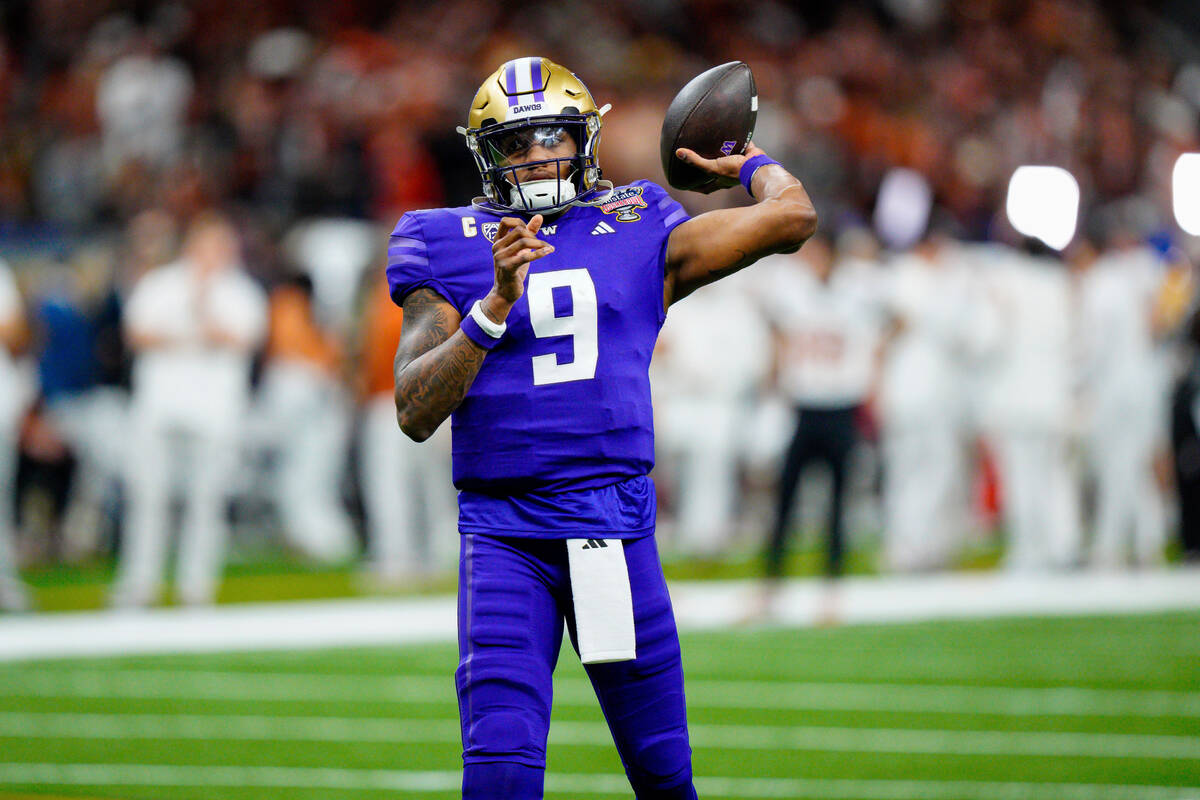 Washington quarterback Michael Penix Jr. (9) warms up before the Sugar Bowl CFP NCAA semifinal ...