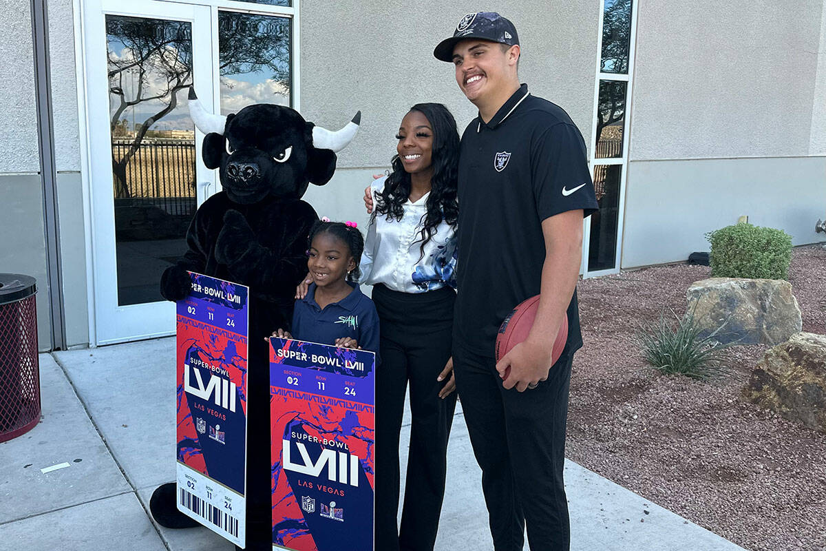 Raiders quarterback Aidan O'Connell (right) surprises SLAM! Nevada teacher Nayda Peace with two ...