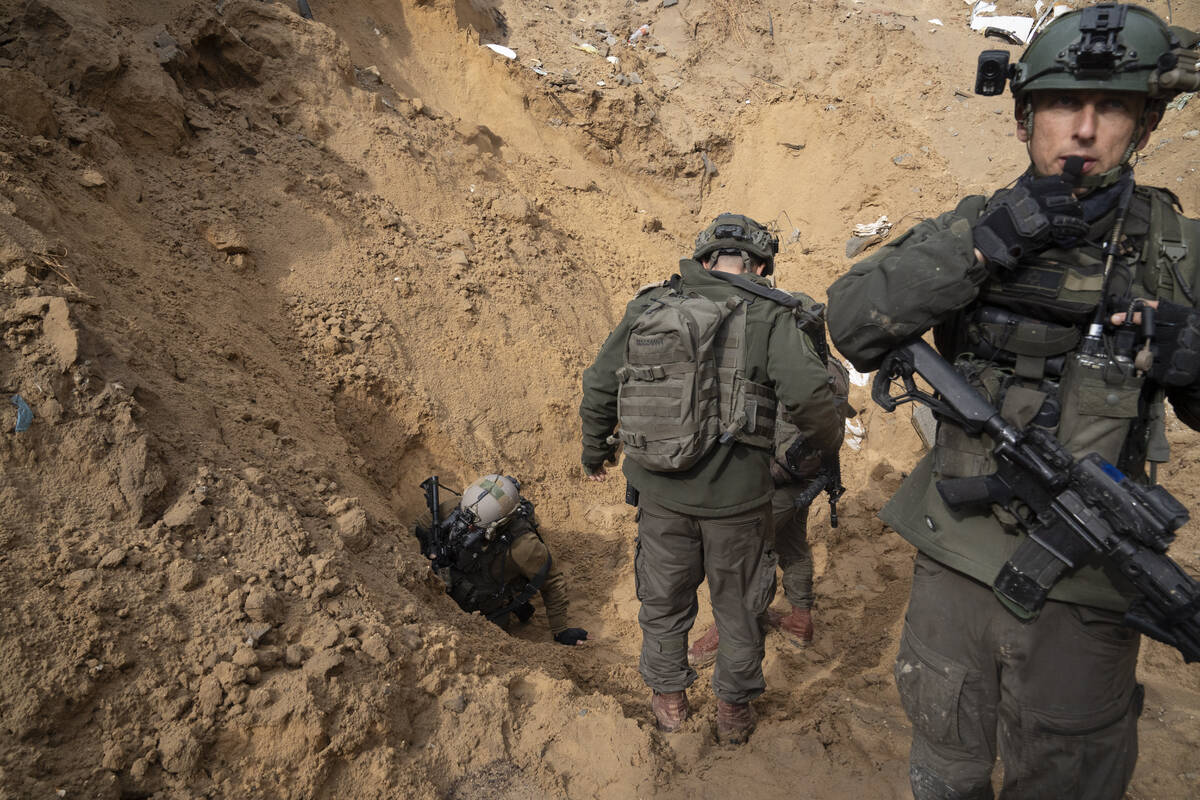 Israeli soldiers enter a Hamas tunnel underneath a cemetery during the ground offensive on the ...