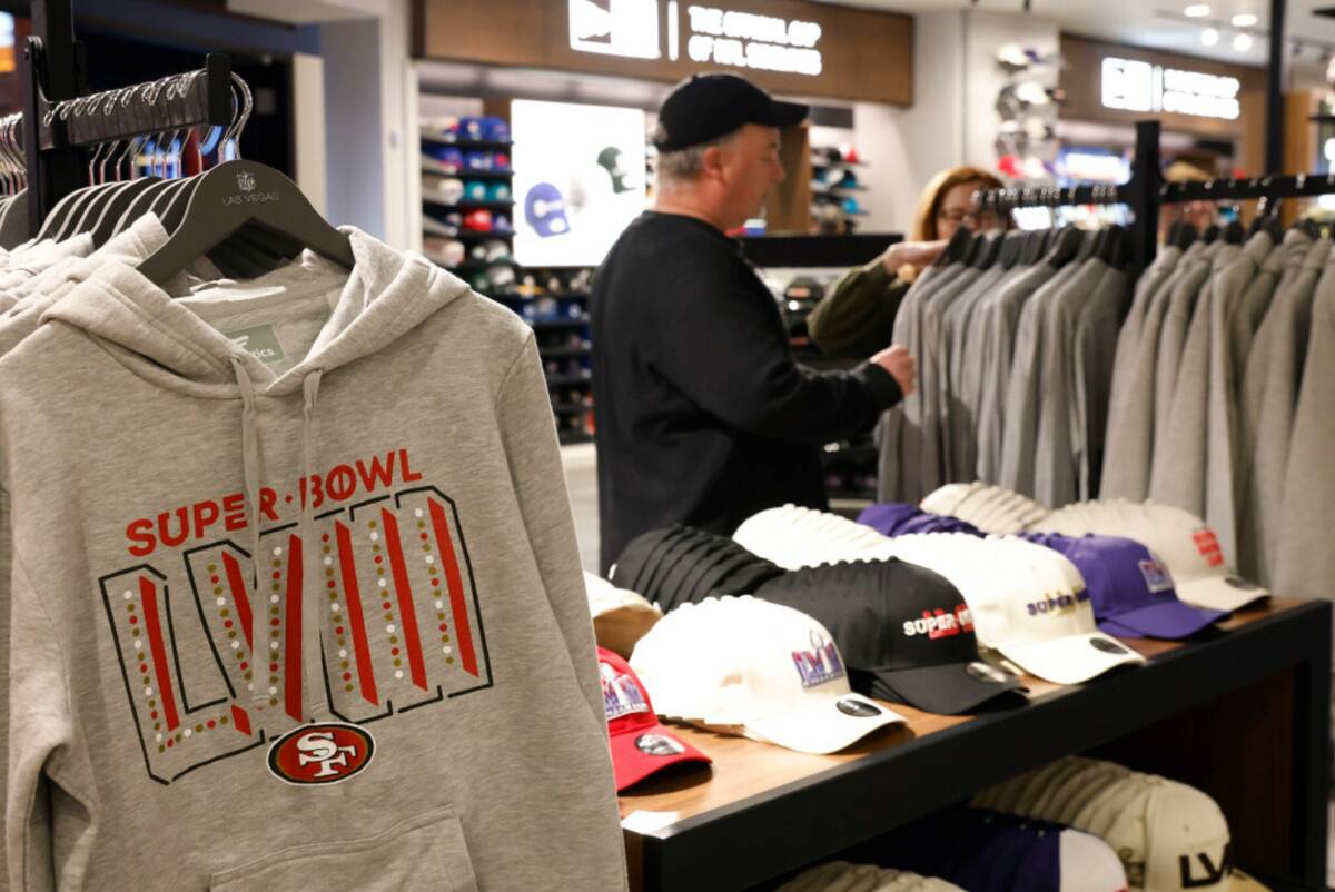 Shoppers, including Jean Ziak of Chicago, right, a Kansas City Chiefs fan, checks out Super Bow ...