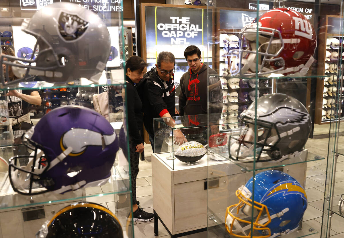 Shoppers check out Super Bowl LVIII merchandise at the NFL Las Vegas store at the Forum Shops, ...