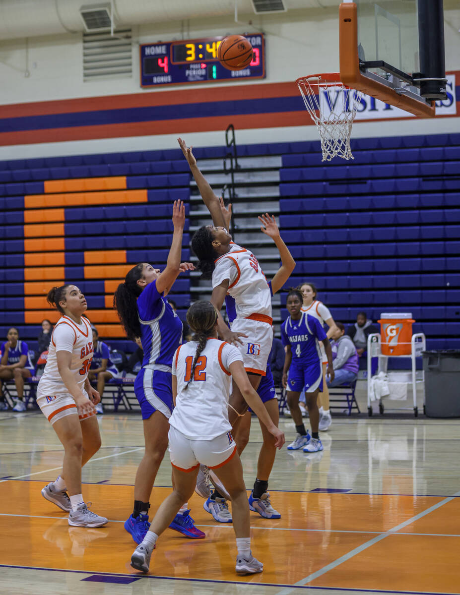 Bishop Gorman’s Neeyah Webster (33) attempts to make a rebound shot against Desert Pines ...