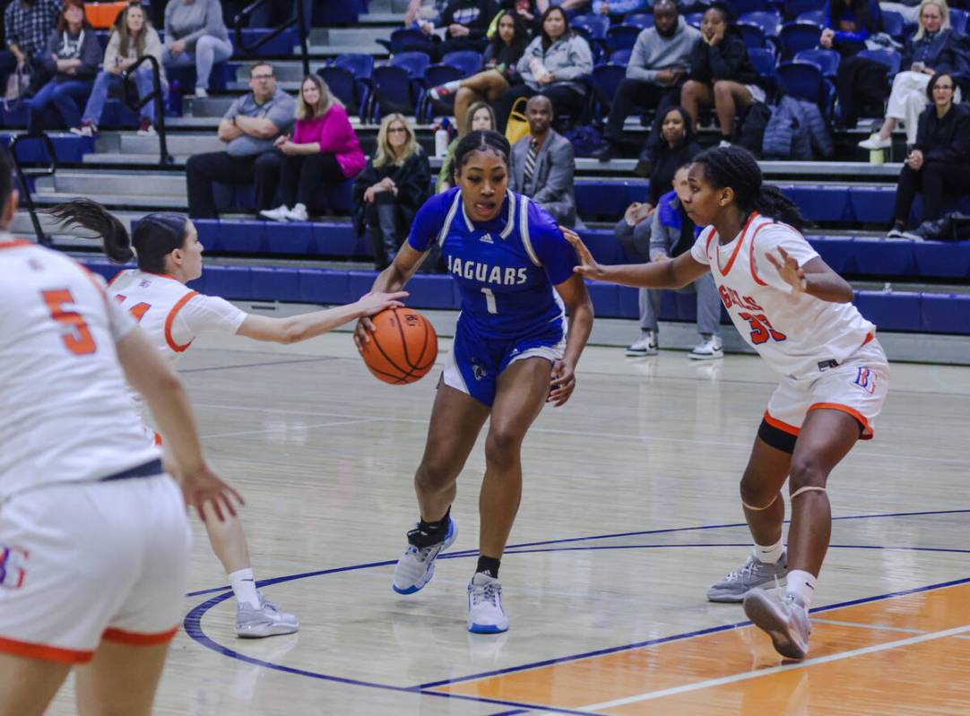 Desert Pines’ Siara Bracey (1) attempts to break past Bishop Gorman’s Neeyah Webs ...