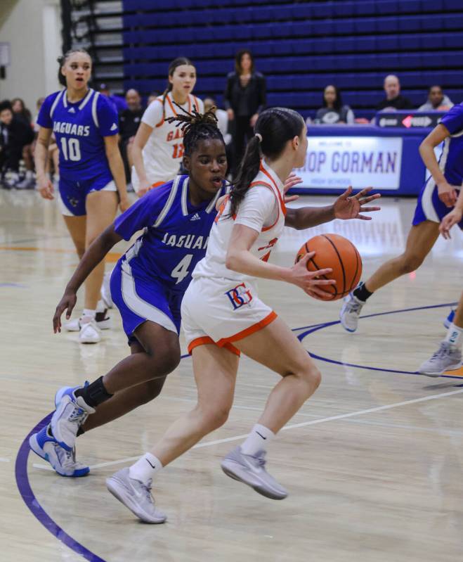 Desert Pines’ Taveah Oliver (4) tries to block Bishop Gorman’s Kenzee Holton (14) ...