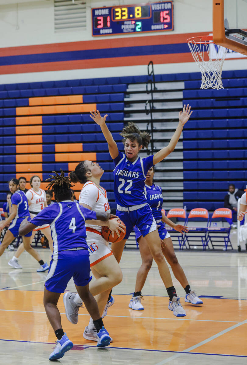 Desert Pines’ Trista Mabry (22) attempts to block Bishop Gorman’s Savannah Searcy ...