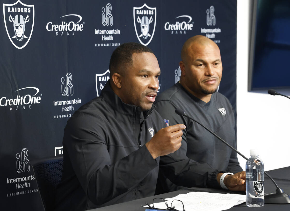 Champ Kelly, Raiders interim general manager, left, speaks during the press conference as Anton ...