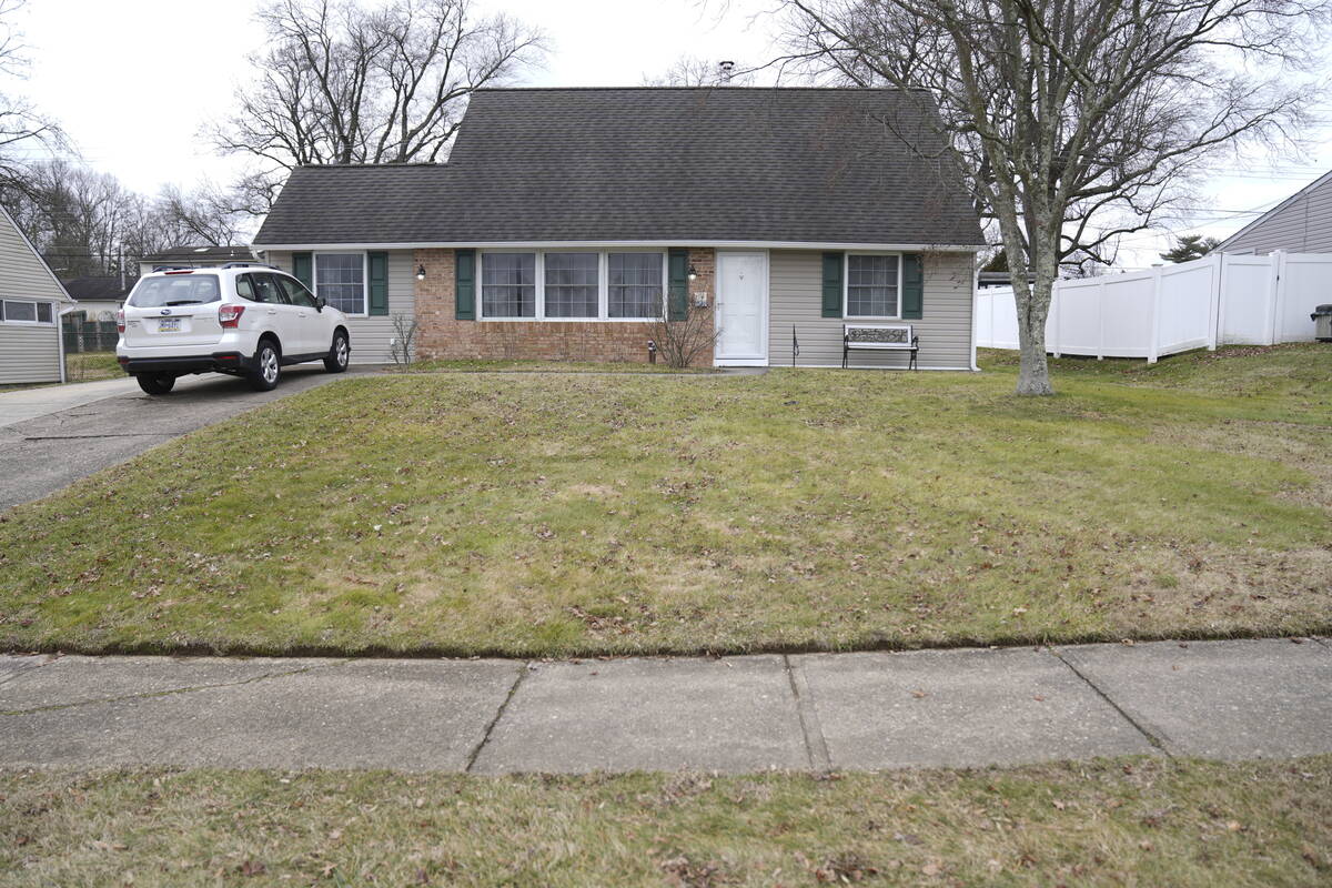 A vehicle is parked in the driveway of a home that was a scene of a murder in Levittown, Pa., o ...