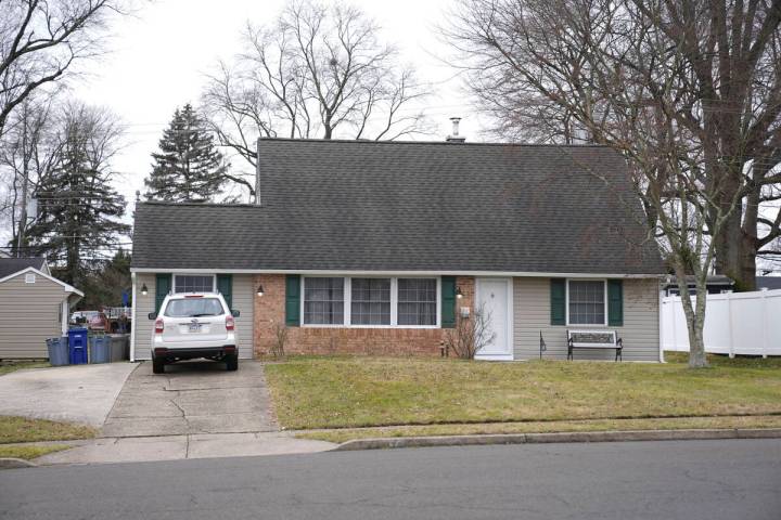 A vehicle is parked in the driveway of a home that was a scene of a murder in Levittown, Pa., o ...