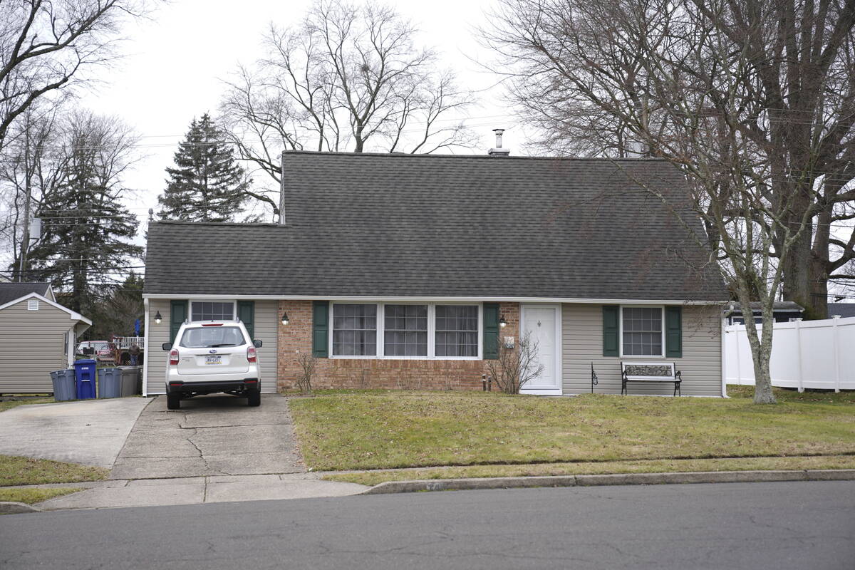 A vehicle is parked in the driveway of a home that was a scene of a murder in Levittown, Pa., o ...