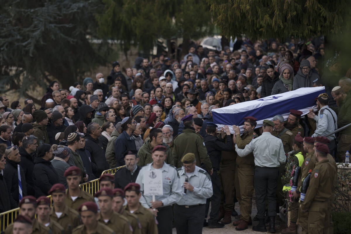 Israeli soldiers carry the flag-draped casket of reservist warrant officer Yuval Nir during his ...