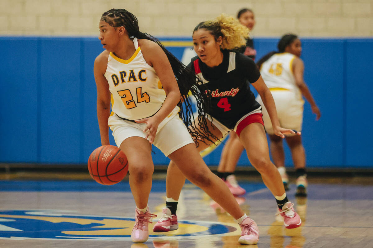 Democracy Prep’s Demi Thompson Lopez (24) dribbles the ball as Liberty’s Satsuki Bradley gu ...