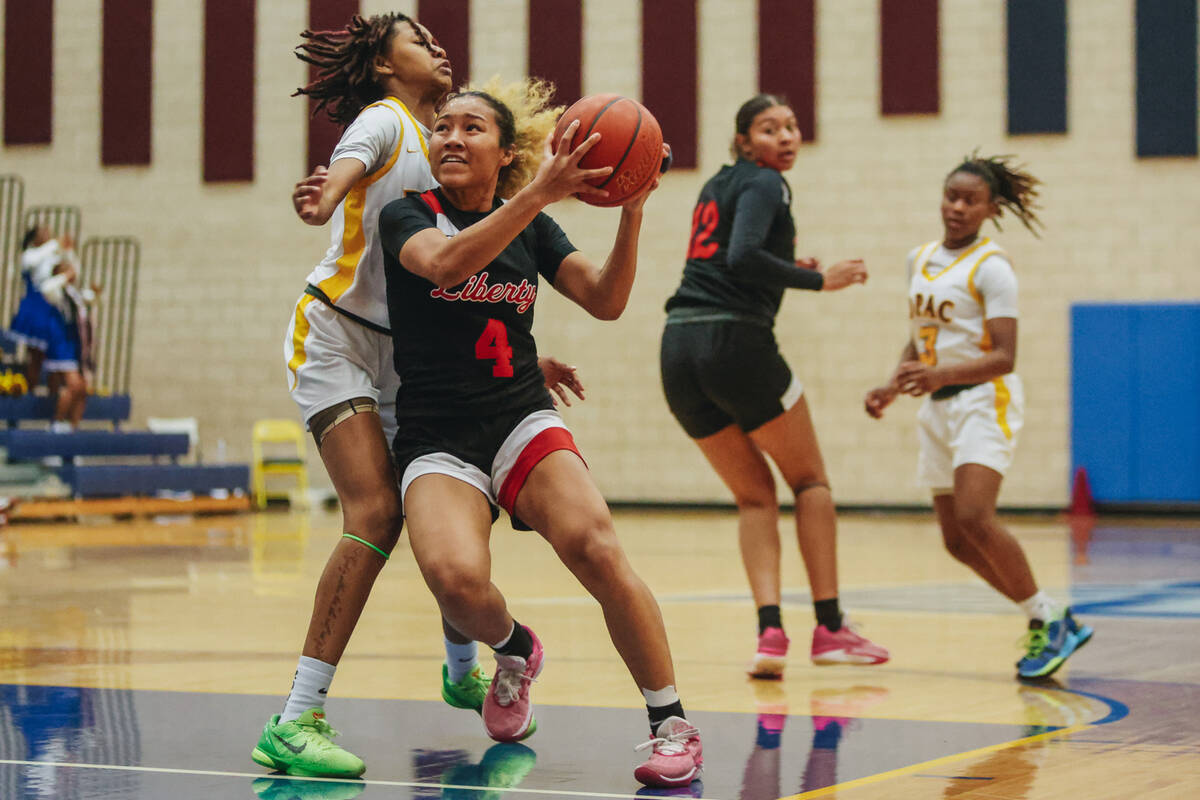 Liberty’s Satsuki Bradley (4) drives the ball up to the basket during a basketball game betwe ...