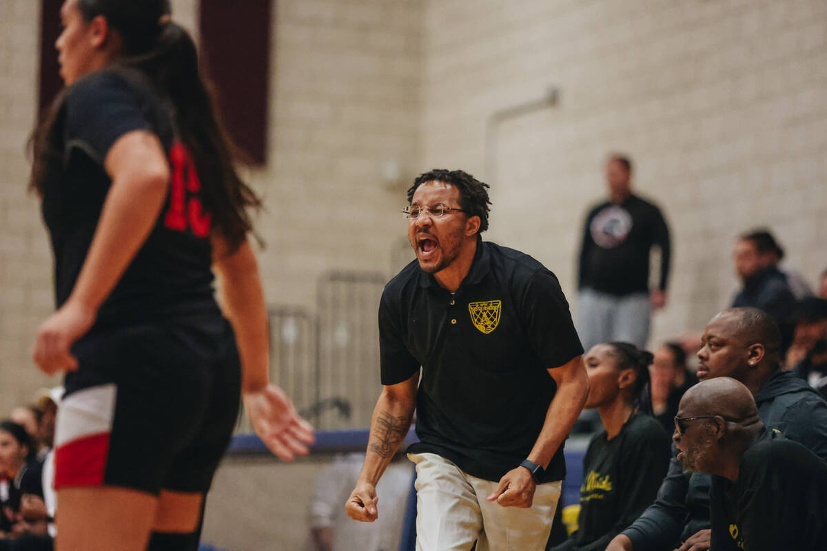 Democracy Prep head coach Julius Barren yells to his team from the sidelines during a basketbal ...