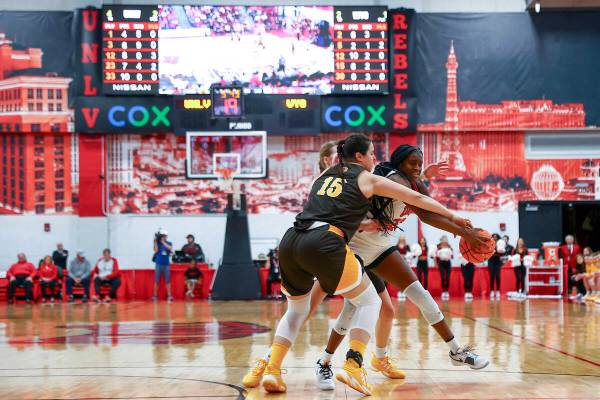 UNLV Lady Rebels center Desi-Rae Young (23) makes her way through Wyoming Cowgirls forward Mart ...
