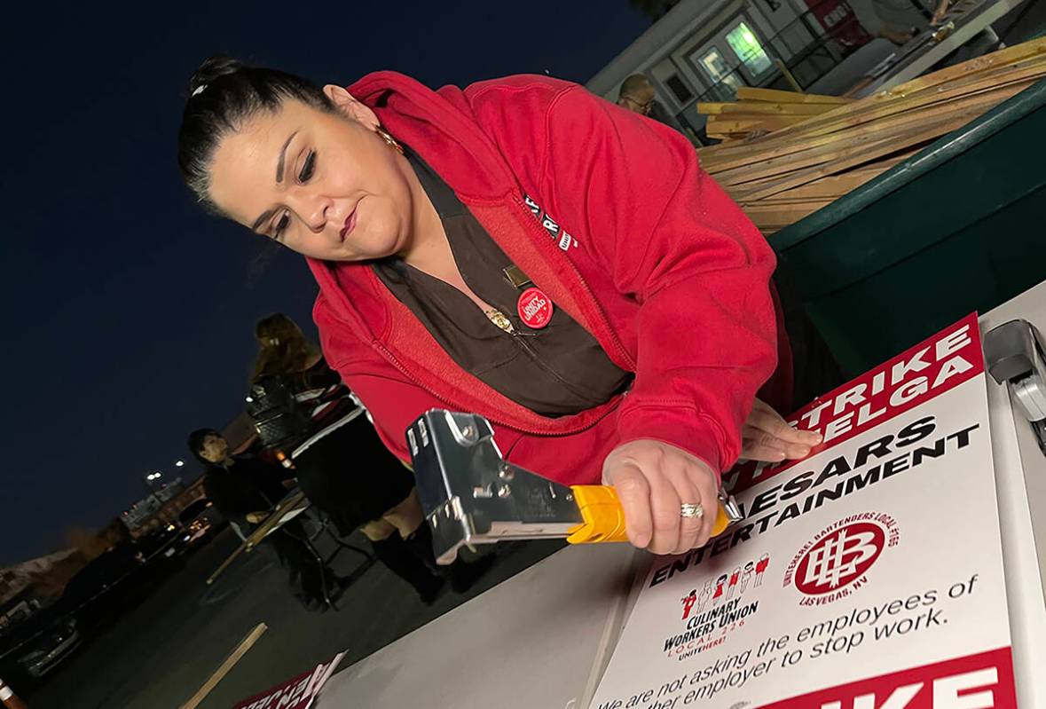 Culinary Local 226 member Mercie Gonzalez prepares strike signs at the union's headquarters on ...