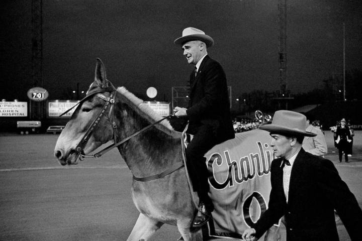 Kansas City Athletics owner Charlie Finley sits astride the team's mascot, "Charlie O,&quo ...