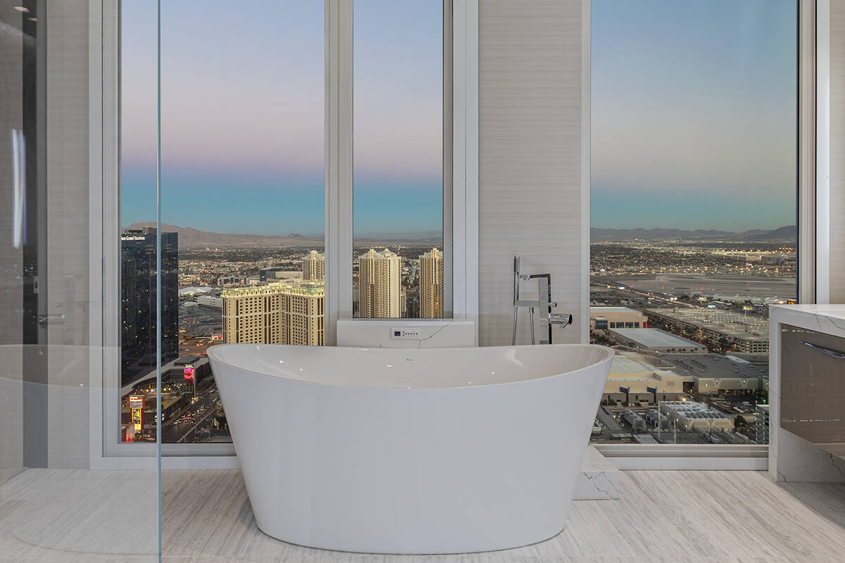 The master bath showcases a soaking tub with Strip views. (BHHS)