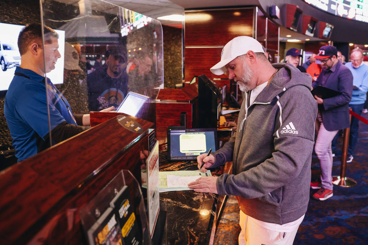 A bettor places prop bets for the Super Bowl at the Westgate SuperBook on Thursday, Feb. 1, 202 ...