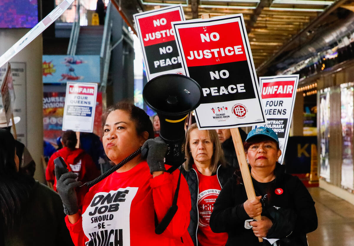 Members of the Culinary Local 226 picket outside the Four Queens Hotel & Casino on Friday, Feb. ...