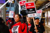 Members of the Culinary Local 226 picket outside the Four Queens Hotel & Casino on Friday, Feb. ...