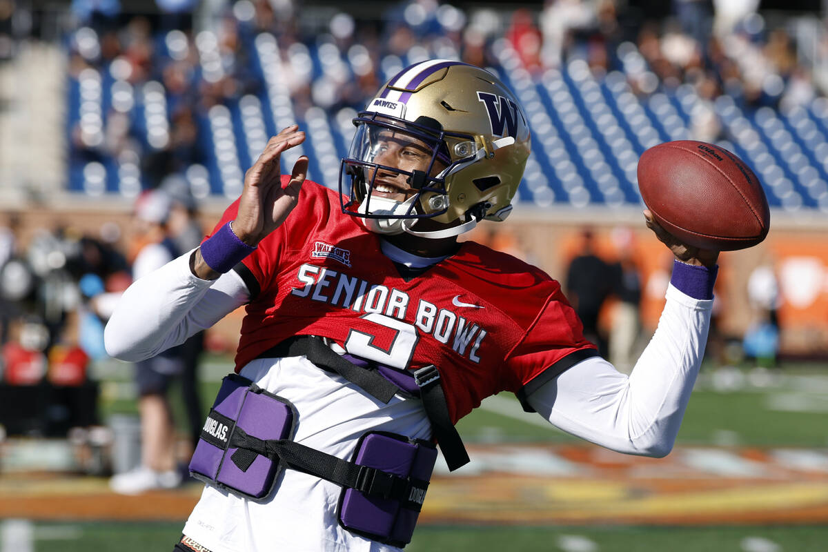 National quarterback Michael Penix Jr. of Washington throws a pass during practice for the Seni ...