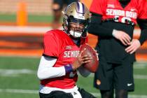 National quarterback Michael Penix Jr. of Washington runs through drills during practice for th ...