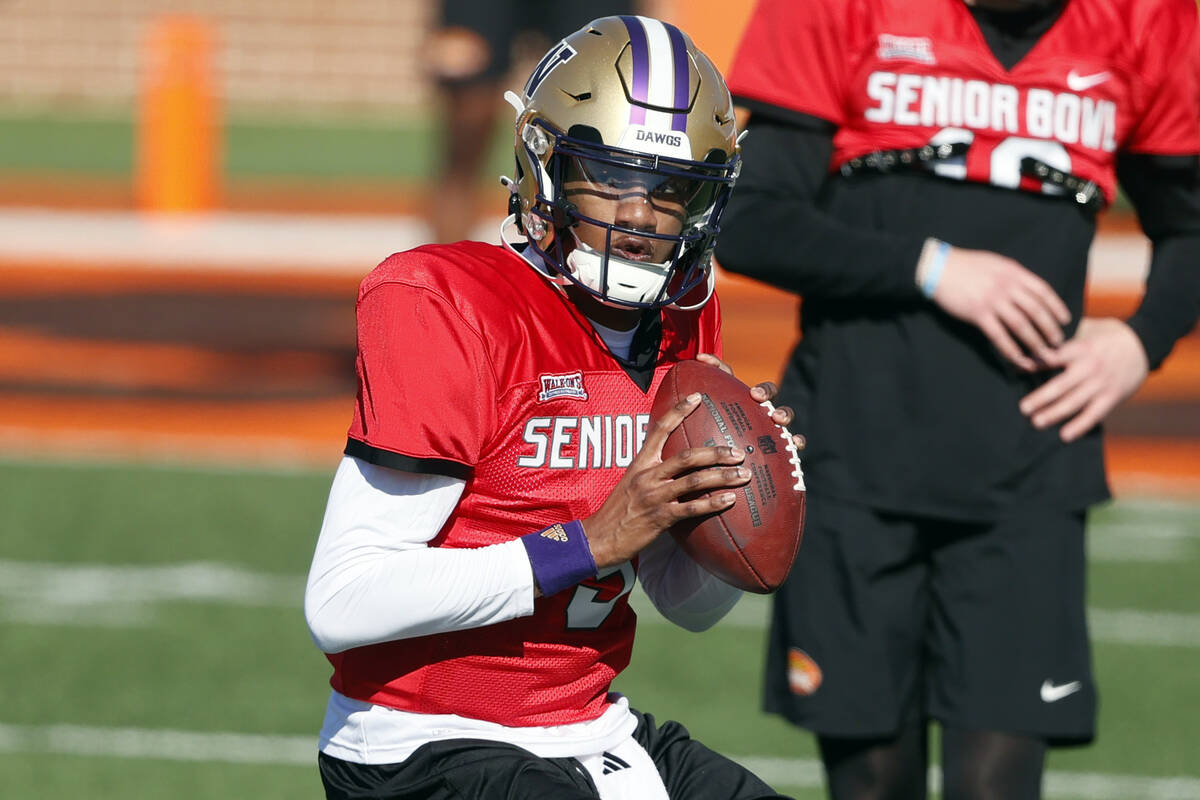 National quarterback Michael Penix Jr. of Washington runs through drills during practice for th ...