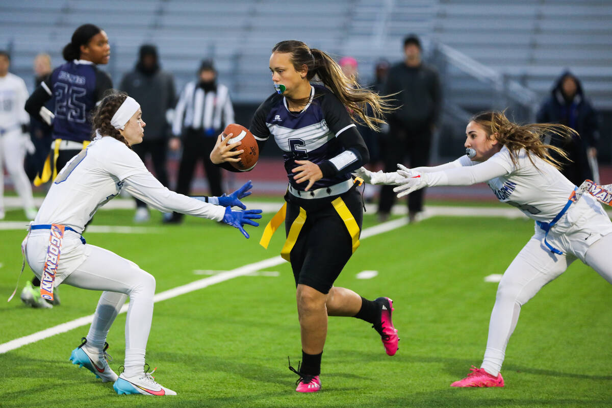 Shadow Ridge’s Chloe Covington (6) looks to evade two Bishop Gorman players during a fla ...