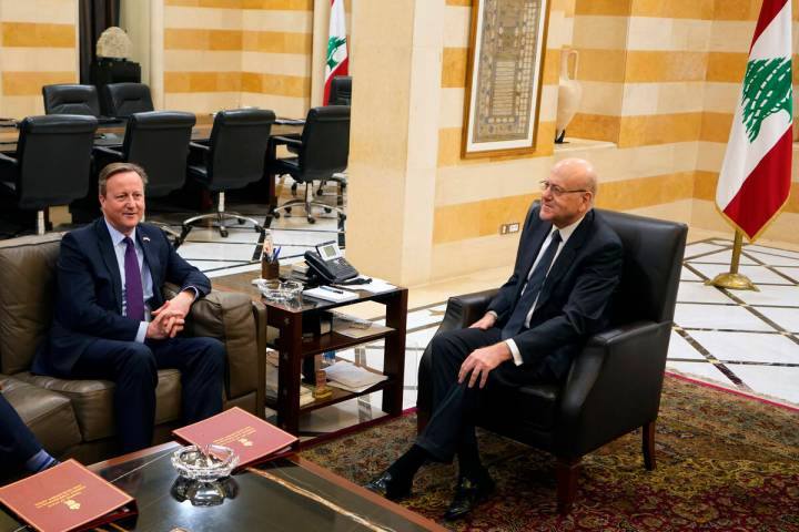 Britain's Foreign Secretary David Cameron, left, meets with Lebanese caretaker Prime Minister N ...