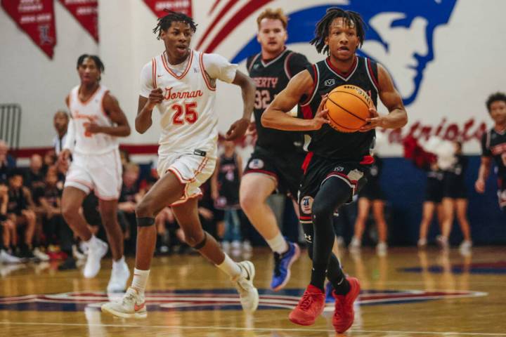 Liberty point guard Jaden Riley (13) passes the ball to a teammate during a game between Bishop ...