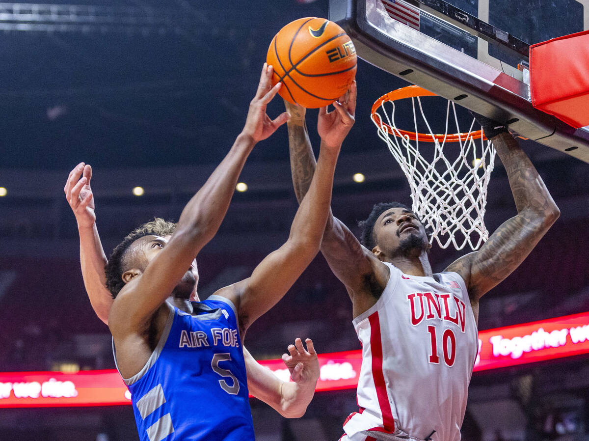 UNLV forward Kalib Boone (10) rejects a shot by Air Force Falcons guard Ethan Taylor (5) during ...