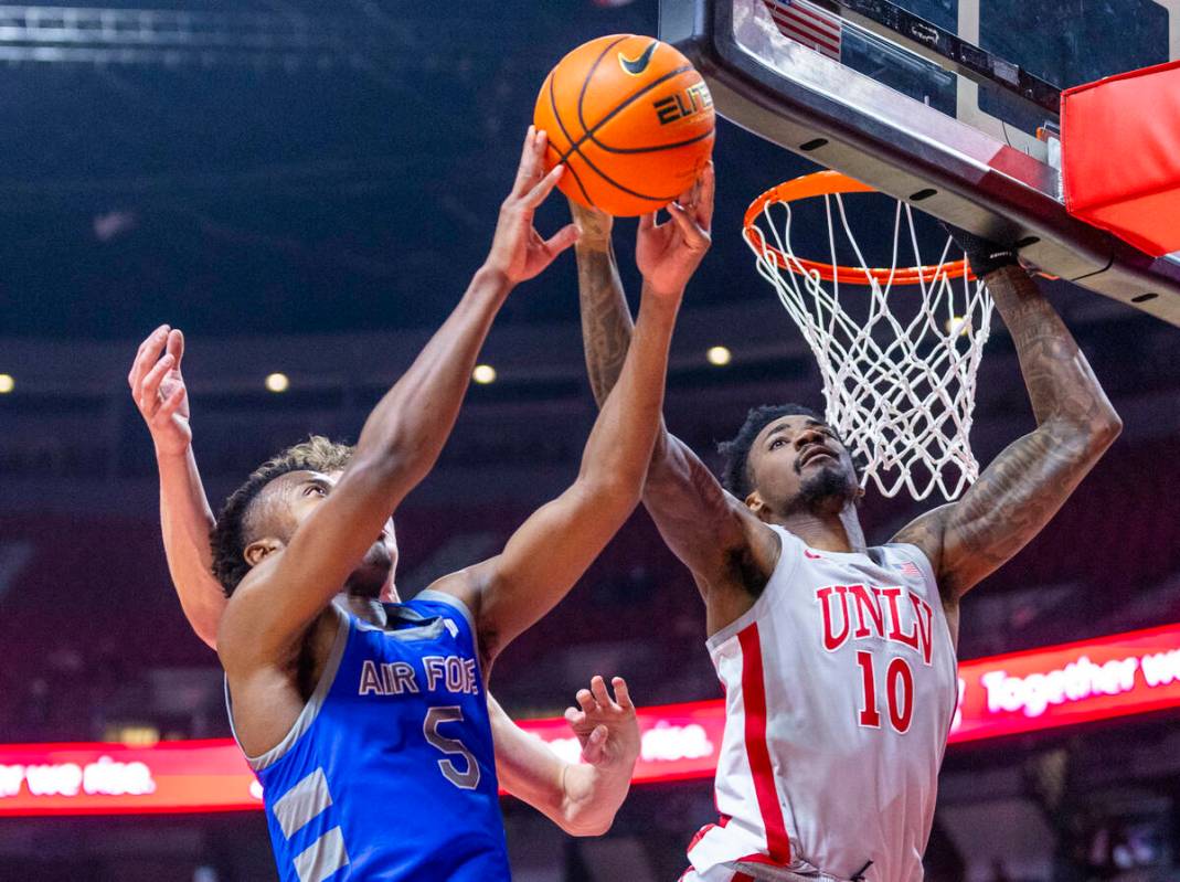 UNLV forward Kalib Boone (10) rejects a shot by Air Force Falcons guard Ethan Taylor (5) during ...