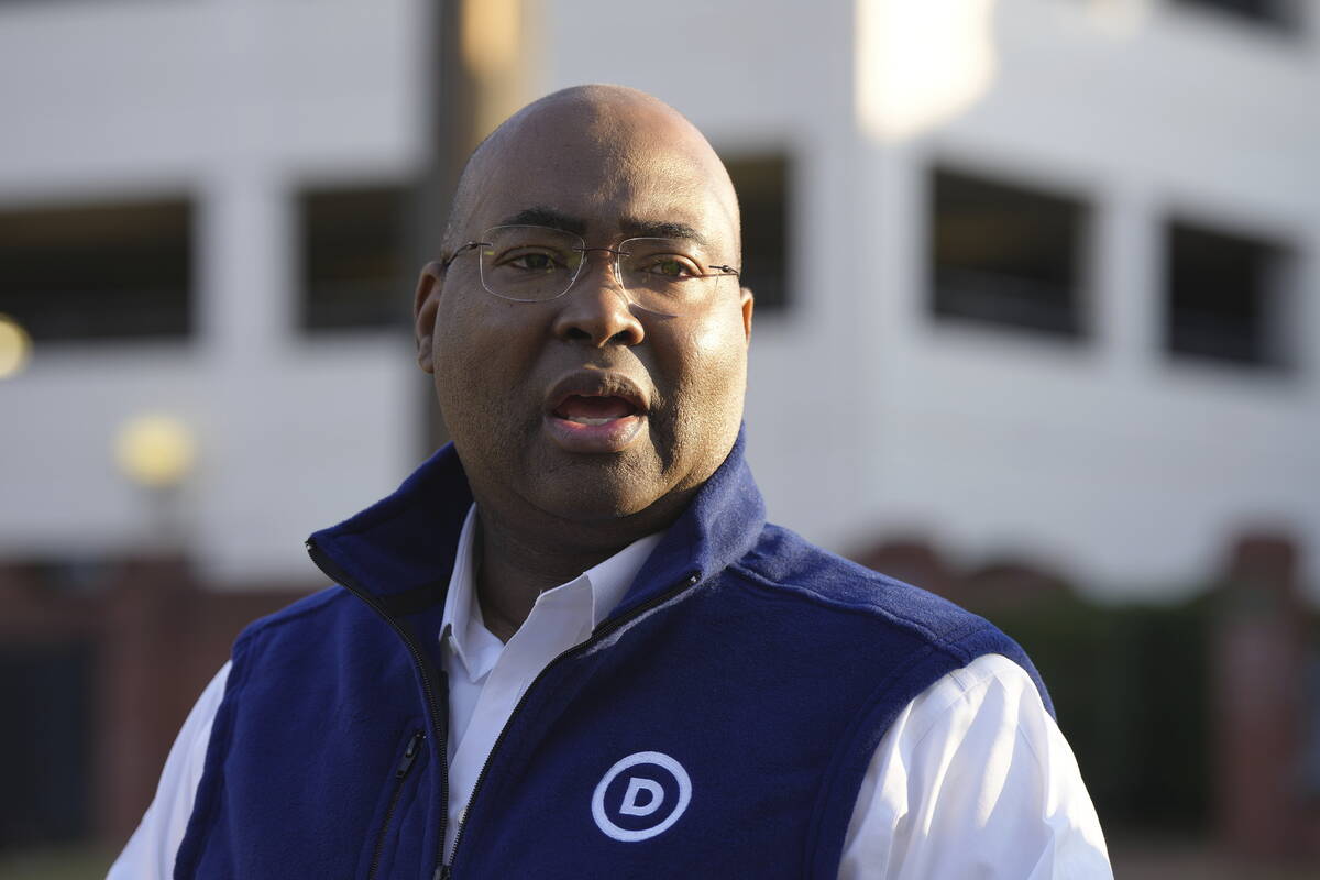 Democratic National Committee Chairman Jaime Harrison talks to reporters as polls open for Sout ...