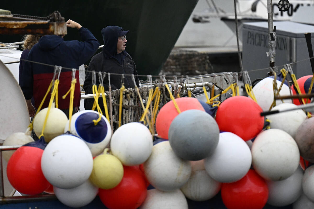 Commercial fishermen check their boat at Tuna Harbor Thursday, Feb. 1, 2024, in San Diego. Heav ...