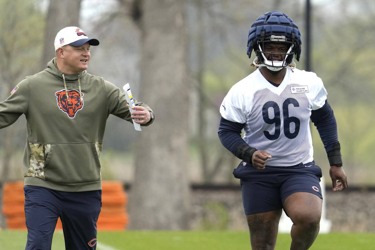 Chicago Bears offensive coordinator Luke Getsy, left, talks to Chicago Bears 2023 draft pick, d ...