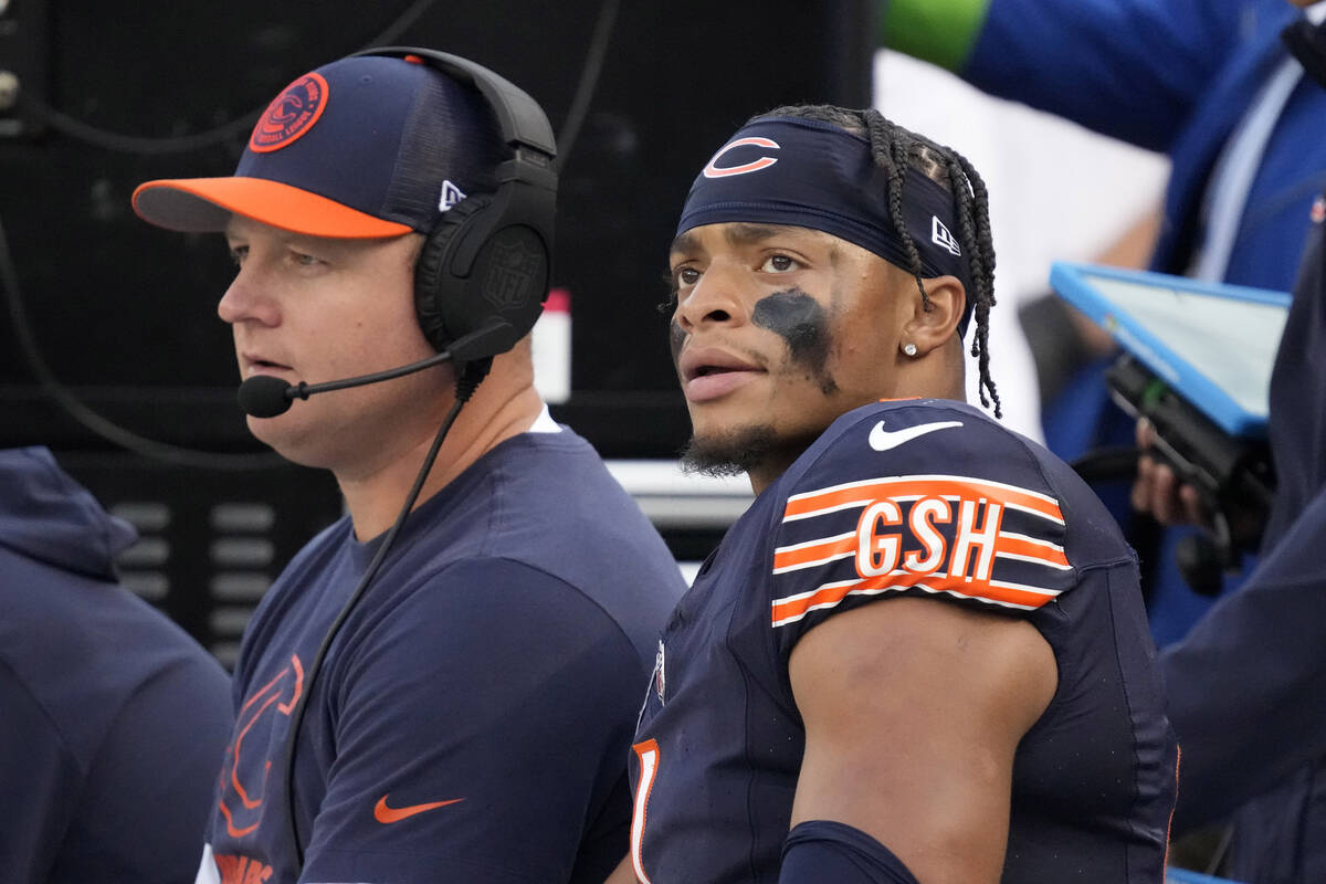 Chicago Bears quarterback Justin Fields sits on the bench with Offensive Coordinator Luke Getsy ...