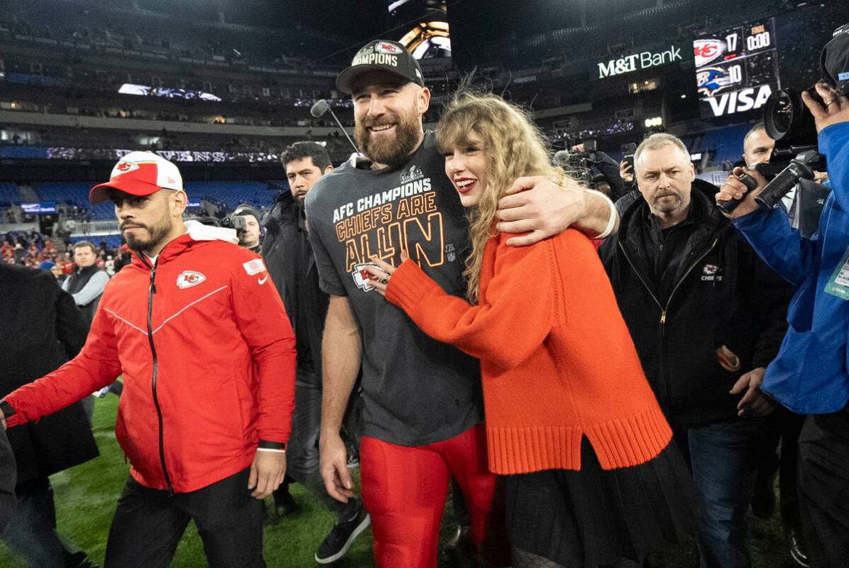 Kansas City Chiefs tight end Travis Kelce and Taylor Swift walk together after an AFC Champions ...