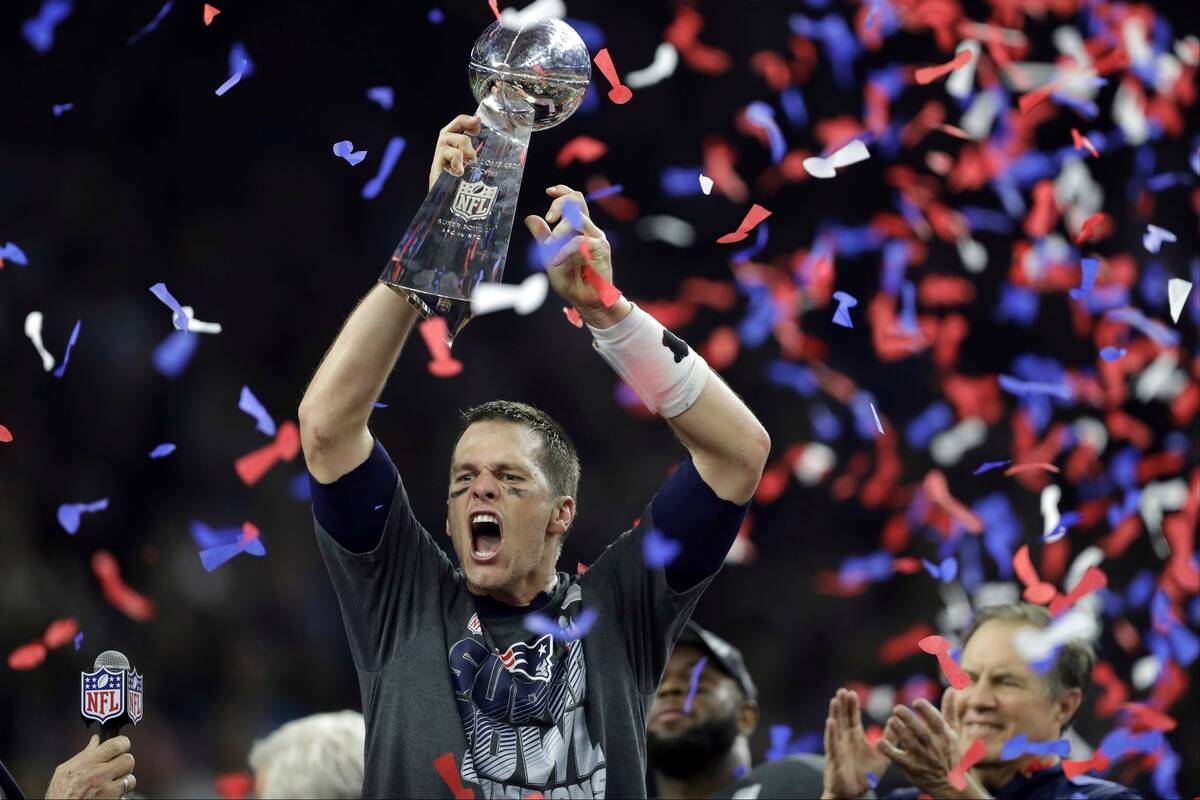 FILE - New England Patriots' Tom Brady raises the Vince Lombardi Trophy after defeating the Atl ...