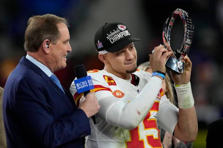 Kansas City Chiefs quarterback Patrick Mahomes (15) holds up the Lamar Hunt Trophy after the AF ...