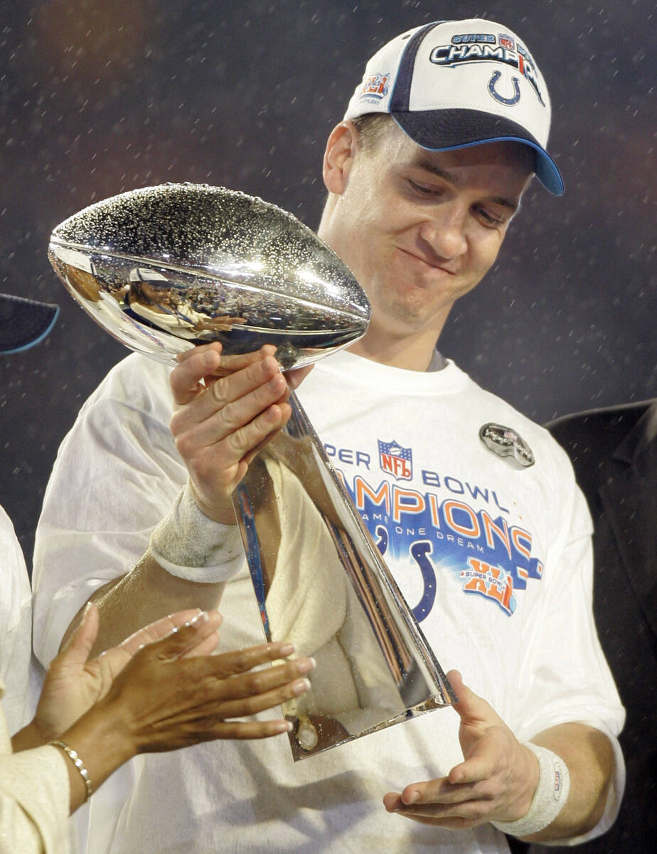 Indianapolis Colts' Peyton Manning (18) holds the Vince Lombardi Trophy after the Colts' 29-17 ...