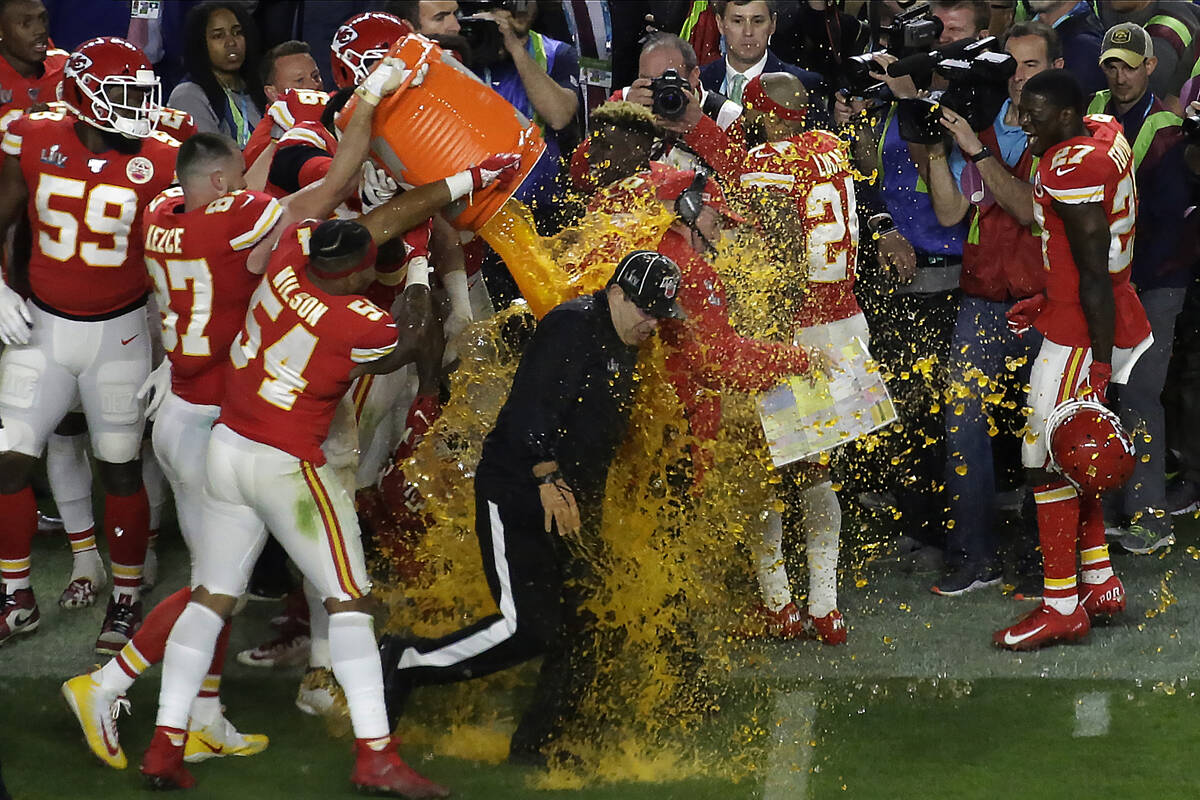 Kansan City Chiefs' players pour a cooler of Gatorade on head coach Andy Reid and members of th ...