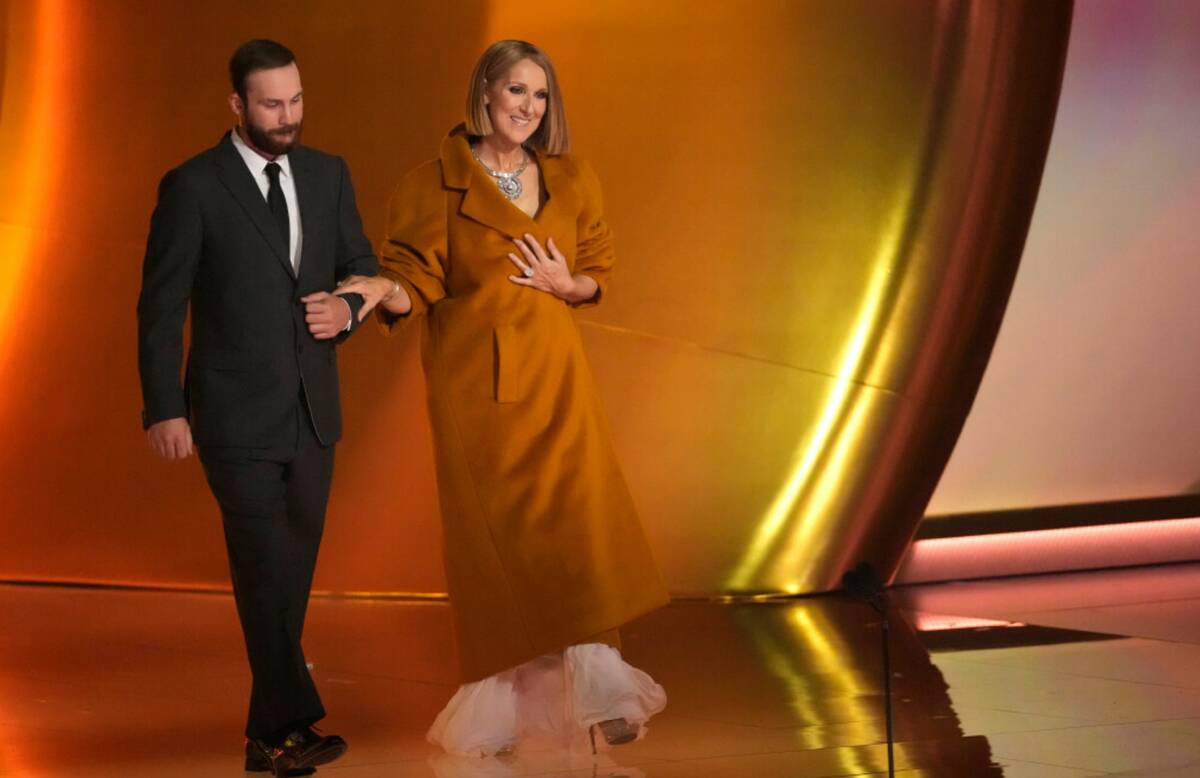 Celine Dion, right, presents the award for album of the year during the 66th annual Grammy Awar ...